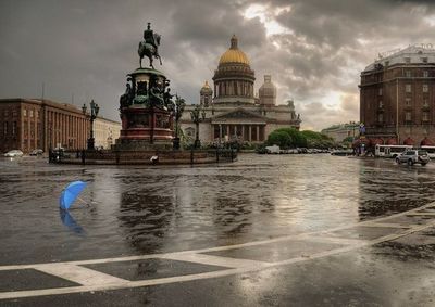 Buildings against cloudy sky