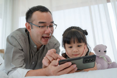 Young man using mobile phone at home