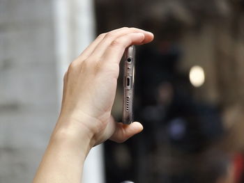 Close-up of hand holding mobile phone