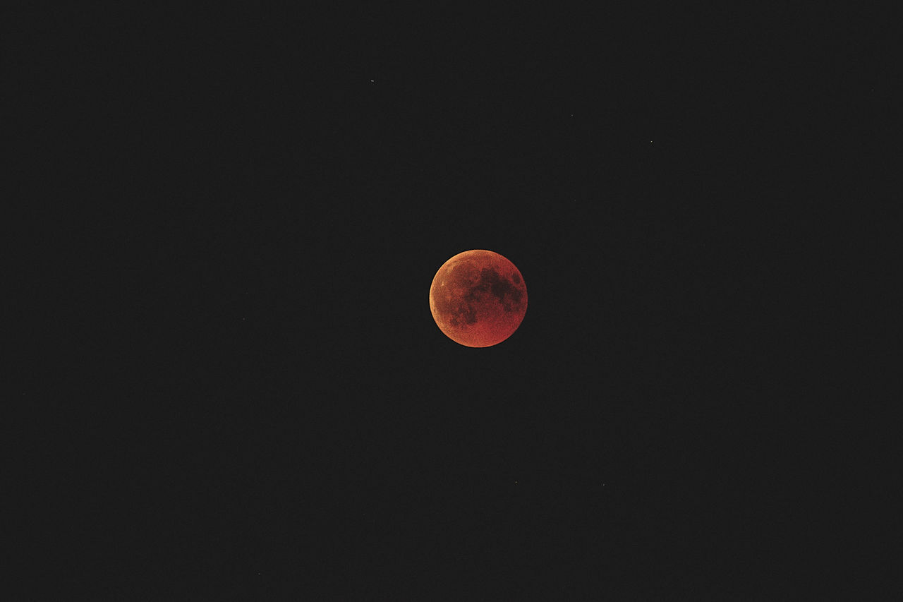 LOW ANGLE VIEW OF MOON IN SKY