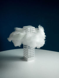 Digital composite image of text on table against sky