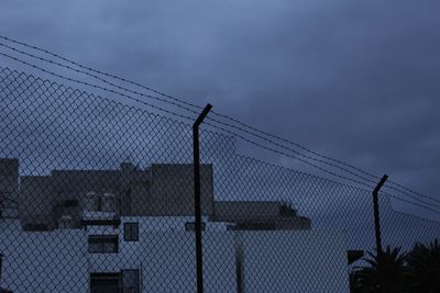 Metal fence against sky