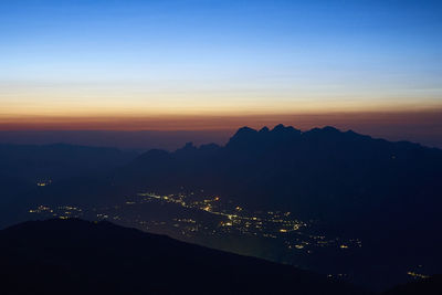 Scenic view of silhouette mountains against sky at sunset