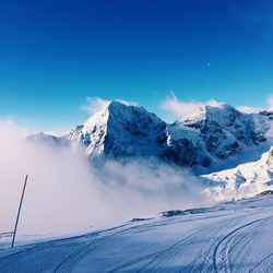 Idyllic shot of snowcapped mountains against blue sky