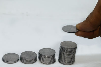 Close-up of hand holding coins