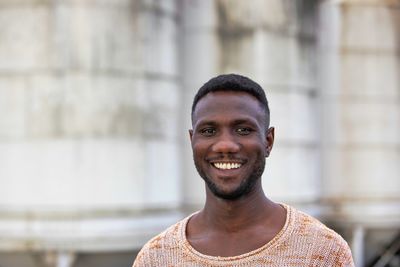 Portrait of young man smiling standing outdoors