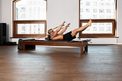 Side view of woman using mobile phone while sitting on table