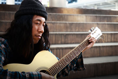 Portrait of man playing guitar