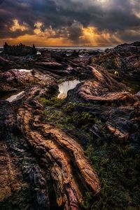 Scenic view of rock formation against sky during sunset