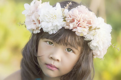 Close-up portrait of cute girl with pink flowers