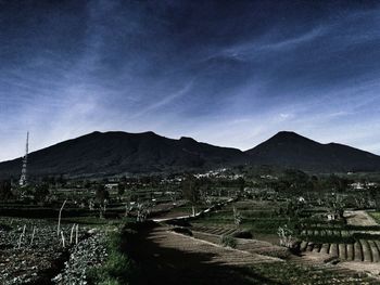 Scenic view of mountains against blue sky