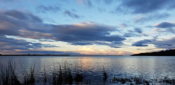 Scenic view of lake against cloudy sky