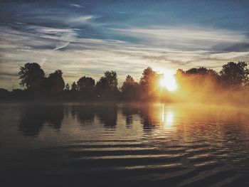 Scenic view of lake against sky during sunset
