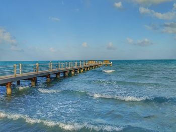 Pier over sea against sky