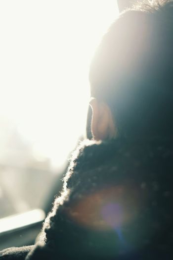 Rear view of man against sky on sunny day