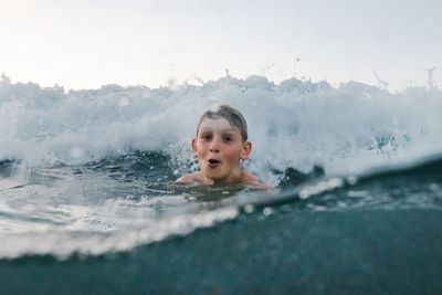 Portrait of boy swimming in water