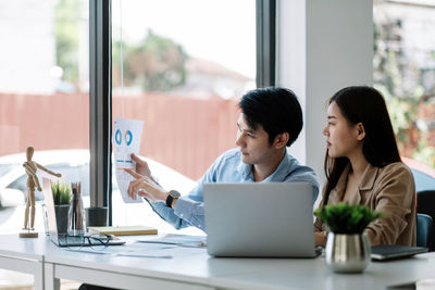 Young woman using laptop at office