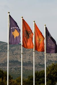 Various flags against sky