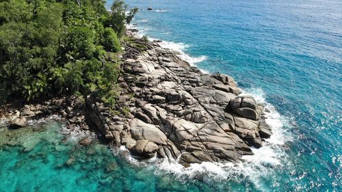 High angle view of rocks by sea