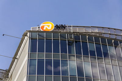 Low angle view of road sign against building