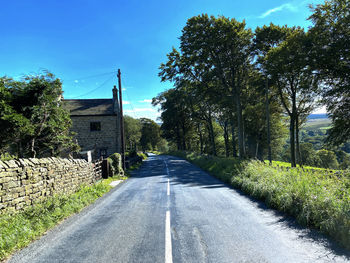 Rural scene, with stone walls, an old cottage, trees and distant fields on, hardisty hill,  k