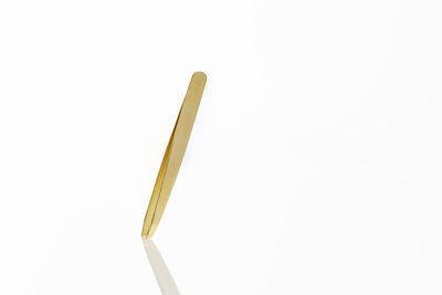 High angle view of colored pencils against white background