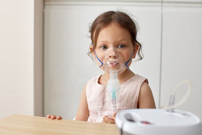 Portrait of young woman drinking water