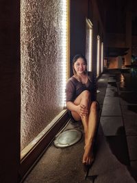 Portrait of a smiling young woman sitting indoors