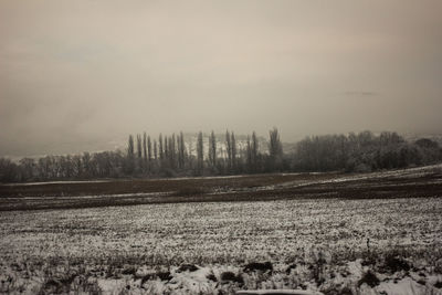 Scenic view of land against sky during winter