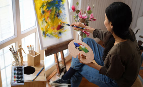 Midsection of woman holding bouquet