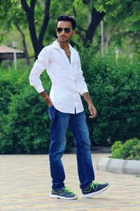 Young man wearing sunglasses standing in park