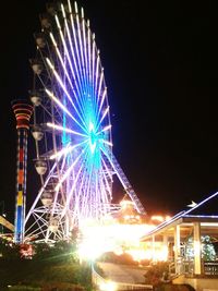 Low angle view of illuminated ferris wheel