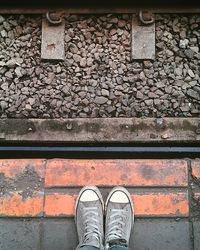 Low section of person standing on tiled floor