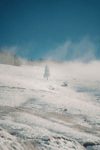 Scenic view of snow covered land against sky