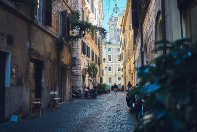 People on street amidst buildings in city