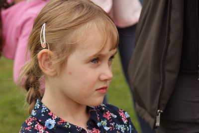 Close-up portrait of cute girl looking down