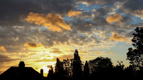 Low angle view of silhouette buildings against sky during sunset