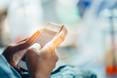 Midsection of man using mobile phone outdoors