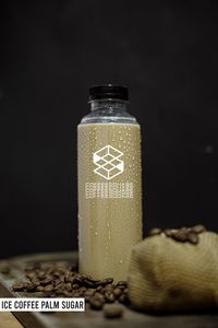 Close-up of glass bottle against black background