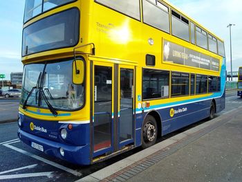 Yellow train on street in city