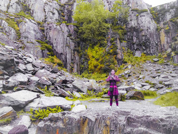 Rear view of woman standing on rock