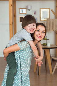 Portrait of young woman standing at home