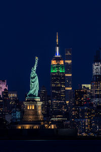 Statue of illuminated buildings at night