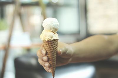 Close-up of hand holding ice cream cone