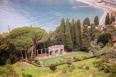 High angle view of trees against calm sea