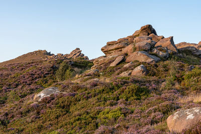 Low angle view of rocks against clear sky