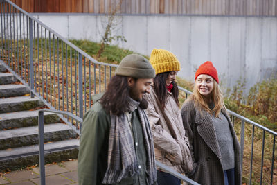 Smiling friends walking together