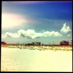 View of beach against cloudy sky