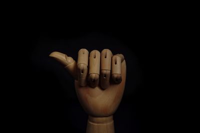 Close-up of human hand against black background