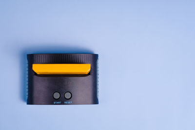 Close-up of usb stick against blue background